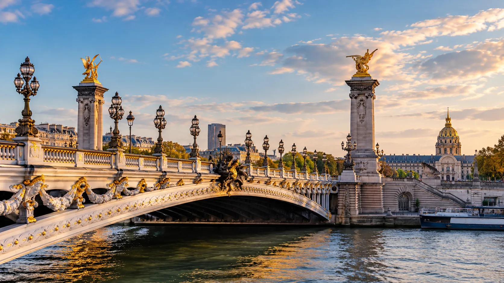 The Pont Alexandre III over the Seine at sunset, with the golden dome of Les Invalides behind