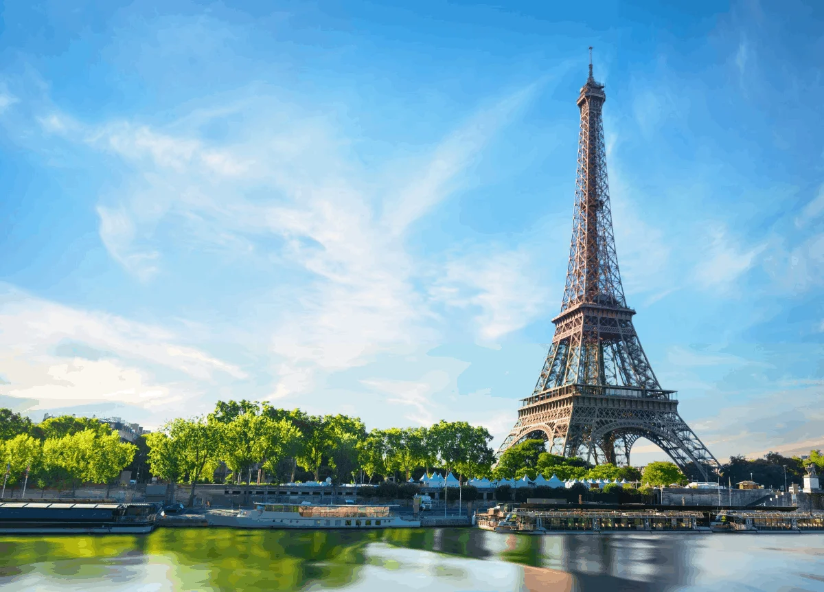 The Eiffel Tower seen from below against a clear blue sky